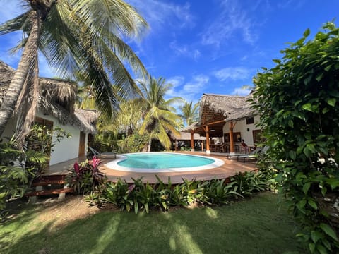 Main Villa to right with pool in the middle with the two bungalows on the left