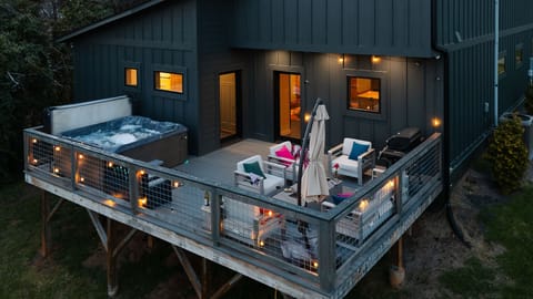 Unwind in luxury! Our stunning outdoor space features a hot tub, cozy seating, a fireplace, and a grill perfect for relaxing under the stars with your love ones!