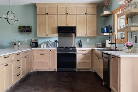 Expansive kitchen includes microwave, dishwasher, toaster, dual coffee maker, 5-burner gas stove, and is fully stocked with flatware, silverware, and glassware. You won't bump into one another here!