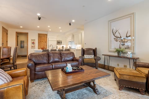 Living Room with plush leather sleeper sofa, Smart TV, and a cozy gas fireplace