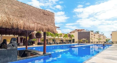 Cool off in Aldea Thai’s resort-style pool with a swim-up bar for easy drinks.