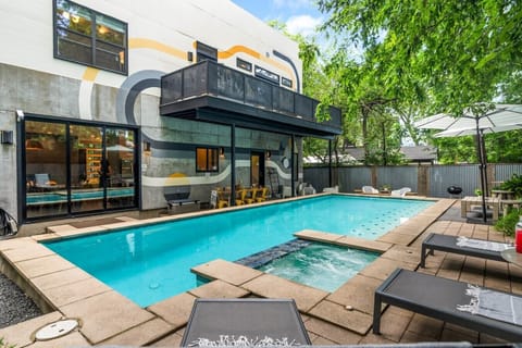 Sparkling pool featuring a custom mid-century-inspired mural by Austin artist Ian Ingram