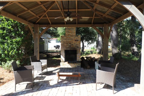 Backyard outdoor area with fireplace.