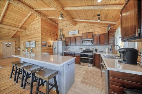 Spacious kitchen with island, modern appliances, and rustic cozy charm.