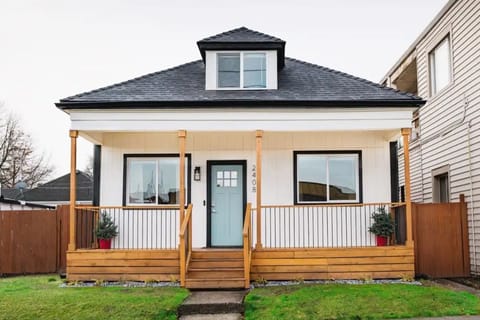 Stylish white home with blue door thats located on main street 6th Ave Tacoma.