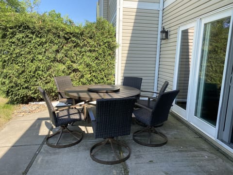 Outside patio seating for 6 on lakeside with additional chairs.