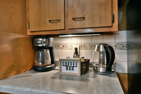 Fully equipped kitchen with water kettle, coffee maker and all the pots, pans, dishes and utensils.