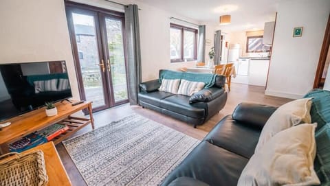 Unwind in the sun-drenched living room—perfect for a movie night on the Smart TV or a quiet afternoon of board games.