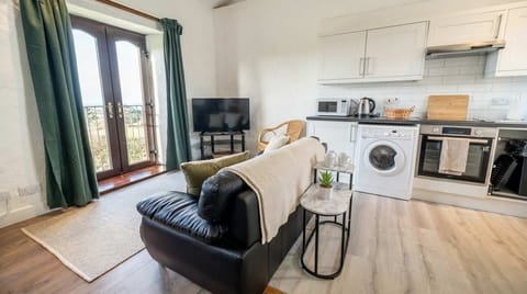 Throw open the French doors to let the fresh air in, connecting the comfortable living space directly to the peaceful outdoor grounds."