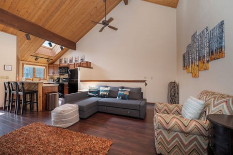 Relax in your spacious mountain retreat with soaring ceilings, cozy seating, and a full kitchen perfect for preparing meals together.