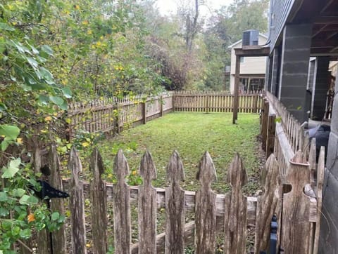 Backyard fenced in area that accesses the upstairs porches