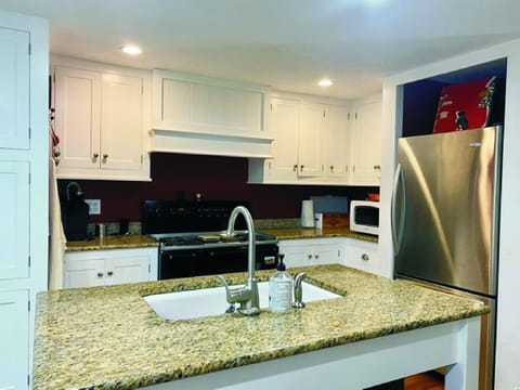 Kitchen with large island and many supplies.