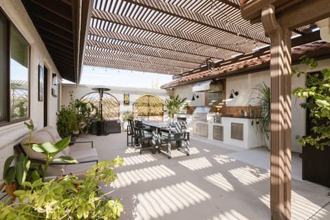 Covered outdoor living room flows from the kitchen to the dining area.
