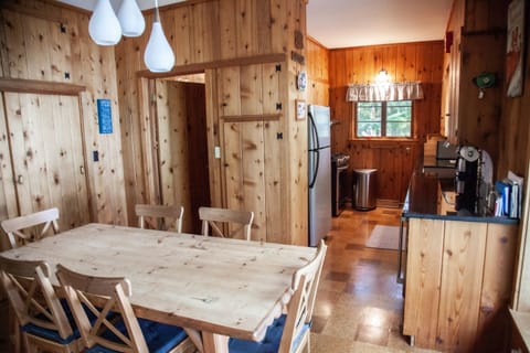 A fully equipped kitchen with stainless-steel appliances and dining area.