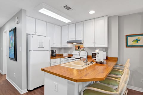 The kitchen is fully equipped and has additional bar seating