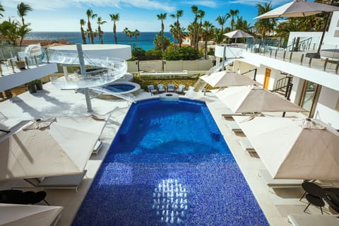 Aerial view of the private heated pool with clear acrylic slides, jacuzzi and loungers at Casa Aqua Blanca, Punta Bella.