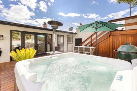 The backyard features a spa, propane heater, smoker, BBQ, and dining set