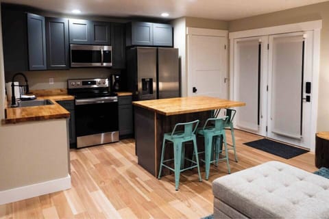 Stainless steel appliances in fully stocked kitchen.