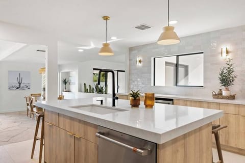 Modern kitchen with a large island and natural wood cabinetry