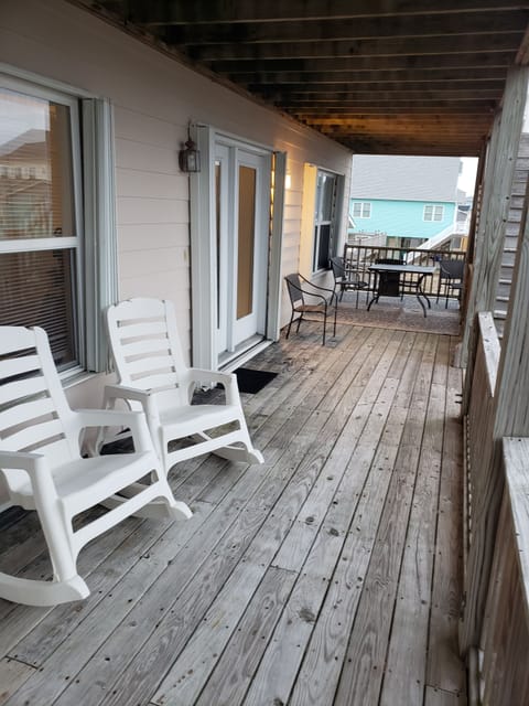 1st floor deck furnished with table and chairs and rockers