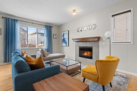 Main floor living area with a gas-lit fireplace and cozy seating options.