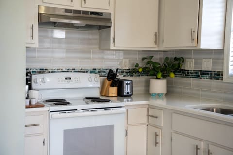 From salt and pepper to wine glasses, the kitchen blends coastal design with practical convenience.