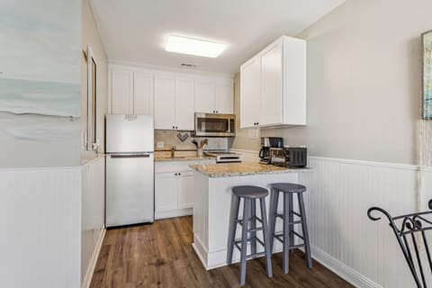 Kitchen with 2 barstools.