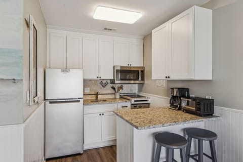 Kitchen with 2 barstools.