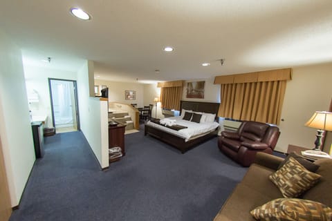 Suite, 1 King Bed, Non Smoking | Desk, laptop workspace, blackout drapes, iron/ironing board (on request)