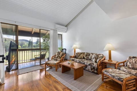 Bright living room w/ comfy seating opens to breezy lanai.