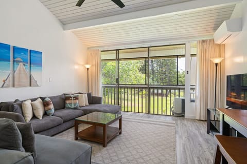 Sunlit living room opening to greenery, perfect for relaxed mornings.