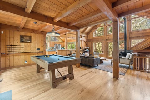 Living Room with pool table and a cozy wood burning fireplace.