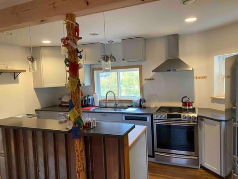 Fully stocked kitchen with gas range, new fridge, dishwasher, and all essentials for cooking.