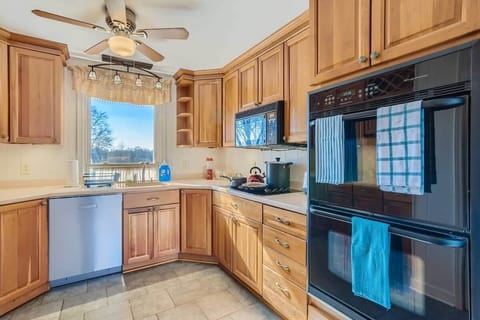 Enjoy the full kitchen with a refrigerator, freezer, oven, stove, microwave, dishwasher, coffee, creamers, mixers, spices, pots, pans, cooking supplies, cutlery, cups, plates, bowls, utensils, small appliances, and many more essentials!