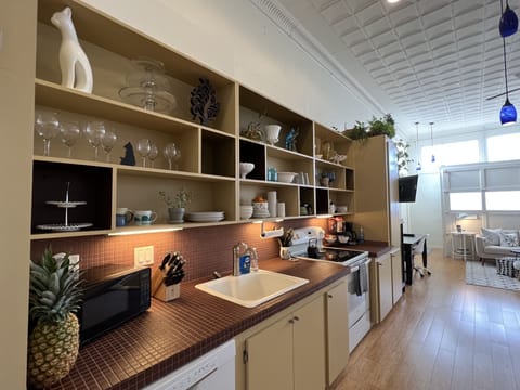 Fully appointed kitchen with major and small appliances, dishes, utensils.