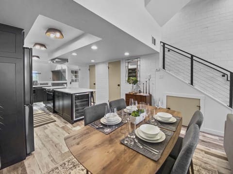 Enjoy meals and company in this modern, open-plan space. Features a stylish dining table and a fully-equipped kitchen with a wine fridge.