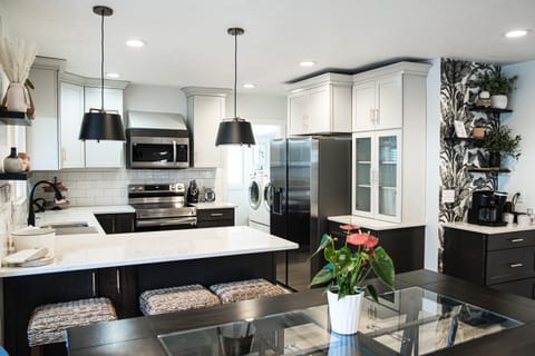 Kitchen with beautiful quartz bar seating, open concept, air fryer oven.