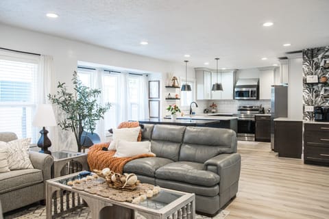 Relax on the La-Z-Boy leather couch enjoy the ambience of the colorful fireplace