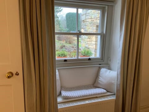 Beautiful window seat in the living room has views of the garden beyond