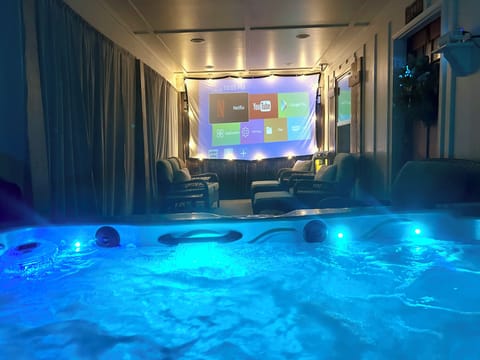 Relax in the hot tub while watching Netflix & more  on a 10 ft home theater!