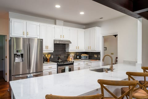The kitchen is open to the great room. Beautiful custom cabinets and stainless steel appliances