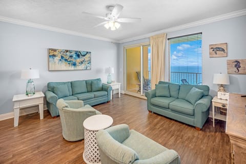 Relax in this spacious living room with ocean views and natural light.