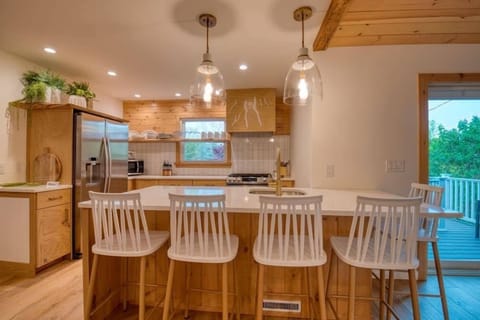 Sink and dishwasher on the "island peninsula" with seating for 5.