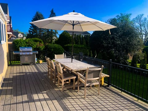 Deck with table, umbrella and Weber grill. Seating for 8. 