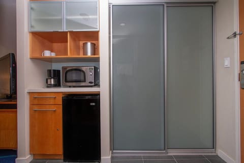 fucntional kitchennete includes mini fride, coffee maker, toaster. electric kettle to prep small meals