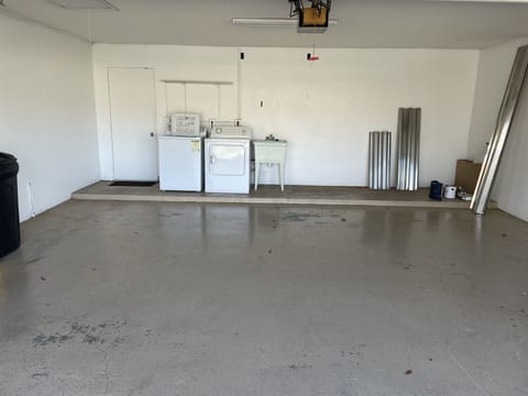 2 car garage with washer and dryer, beach chairs, beach towels and tote