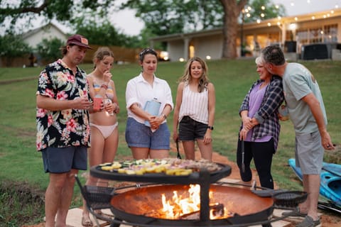 Evening fire pit gathering by the lake at The Blanc in Granbury TX
