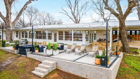 Rear exterior of The Blanc lakefront home with retaining wall and outdoor living
