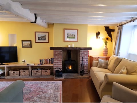 Cosy lounge with log burner.