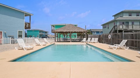 Community Pool with Tiki Hut & Lounge Chairs